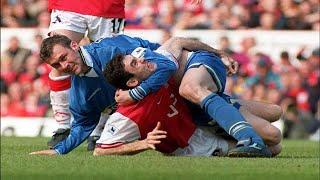 Duncan Ferguson wrestles Martin Keown on the ground.