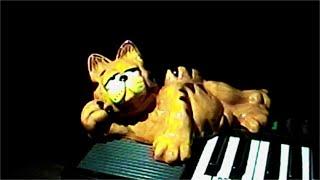 cheesy ceramic Garfield lounging on the keyboard