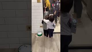 Twin comforts younger brother while their mother cooks in Taiwan