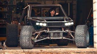 Wow! A man is building a unique all-terrain vehicle in a garage!