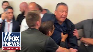 BREAKING: Senator hauled away from Noem's press conference after fiery confrontation