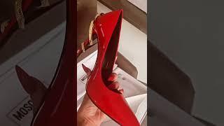 You wont believe what's wrapped around the heels of these red stilettos!