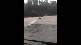 Bridge crosses with full of water flow.