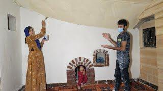 Plastering a nomadic mother's shelter with the help of a skilled craftsman 