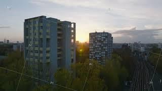 Forwards fly between tall apartment buildings in residential urban borough at sunset. Berlin