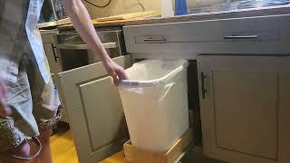 Automatic slide out kitchen garbage bin.