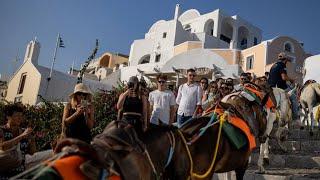 Greece's Santorini bursts with tourists as locals seek cap | REUTERS