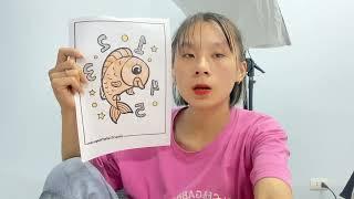 Coloring book with picture of a goldfish swimming happily