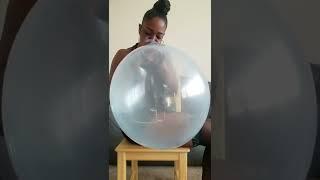 Blowing white balloon to pop