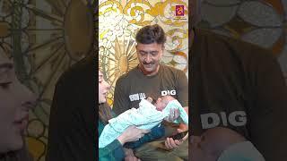 Both parents are lovingly caring for their new daughter, cherishing every precious moment together.