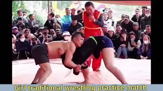 practice wrestling match between tall girl and strong boy. matt traditional wrestling fight kushti