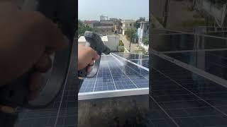 Washing solar panels with high pressure water gun