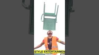 Risky Man Balance A Chair On His Head While Standing On A Ladder