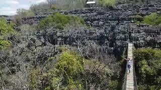 Blonde Girl on the suspension bridge over the precipice - Ankarana NP - Madagascar - Africa