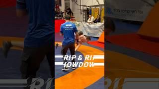 Grip & Rip Showdown! ‍️Wrestlers in a fierce clash, trading takedowns and spins, one hits the mat