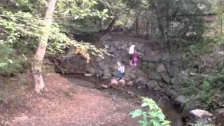 Creek crossing. Woman and two children