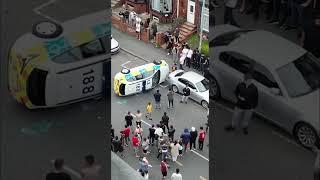 CHAOS erupted on a residential street in Leeds as an angry mob overturned cop car