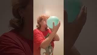 blowing up a blue balloon