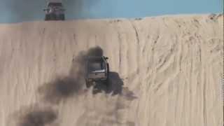 White Chevy Diesel Truck climbs test hill Silver Lake Sand Dunes