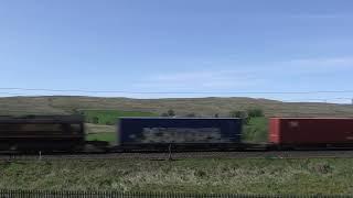 Southbound DB Cargo intermodal headed by a former EWS engine at Scout Green, UK