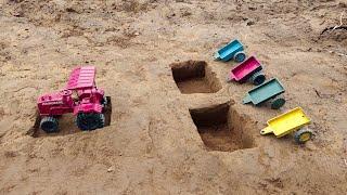 Children cross the ditch in the trolley of mini tractor and load soil in the trolley