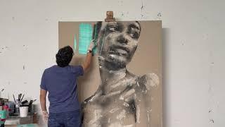 Mario Henrique painting in his studio