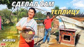 Married couple building a greenhouse. Garden decor from trash. Life in the villageash