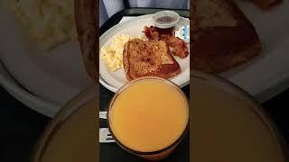 bacon eggs french toast butter syrup so much orange juice it's going to spill.