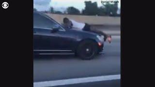 Man calls 911 while clinging to speeding car
