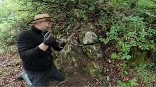 The treasure hunter took out huge gold coins from the rock