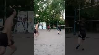 Beach volleyball, throwing the ball under the net to the right edge.