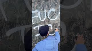 Graffiti artist tagging up the walls at City Hall in downtown LA during the protest #shotbydre
