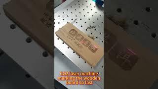CO2 laser marking machine engraving on wooden boards.