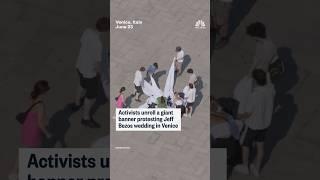 Activists unroll a giant banner protesting Jeff Bezos wedding in Venice