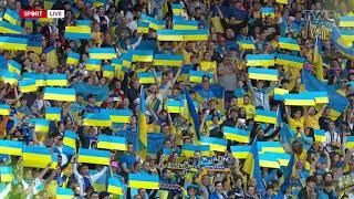 The Ukrainian players and fans sing their national anthem at Hampden Park. 