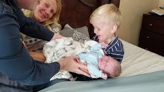 He's Here! David and Priscilla Waller show their children their fifthborn baby for the first time.