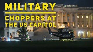 Military and police helicopters land at the US Capitol this evening.