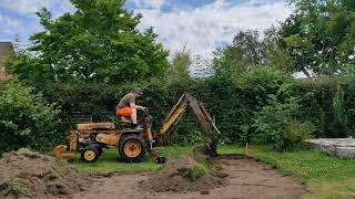 Mini backhoe Hinomoto HB 501 in action with a homemade 100cm flat bucket.