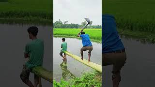 Two people are standing near the water.