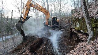 Digging in a driveway with a new excavator