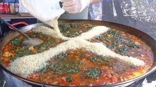 Spanish Paella with Pork, Sausages, Rice and Spinach. London Street Food