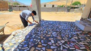 "Decorating and beautifying the front porch with broken tiles by Abu and Ali"