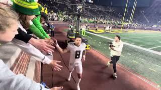 Dillon Gabriel shakes hands with Duck Fans at the Big House