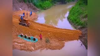 A small bulldozer and a small excavator worked together to successfully intercept the flow.