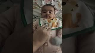 Drooling and mimicking chewing while others eat are early signs a child is ready for solids.