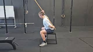 Seated Broomstick assisted hip hinge.