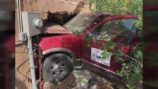 Car crashes through family's garage, driver flees