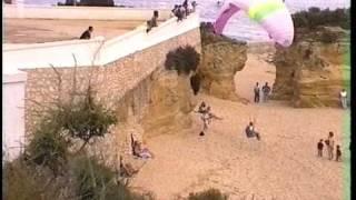 Paraglider foot launch from beach then soars castle wall 1997.05 Lagos Portugal