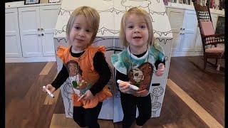 Twins color their gingerbread house