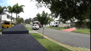 Queensland bus traveling dangerously on small road in Noosaville